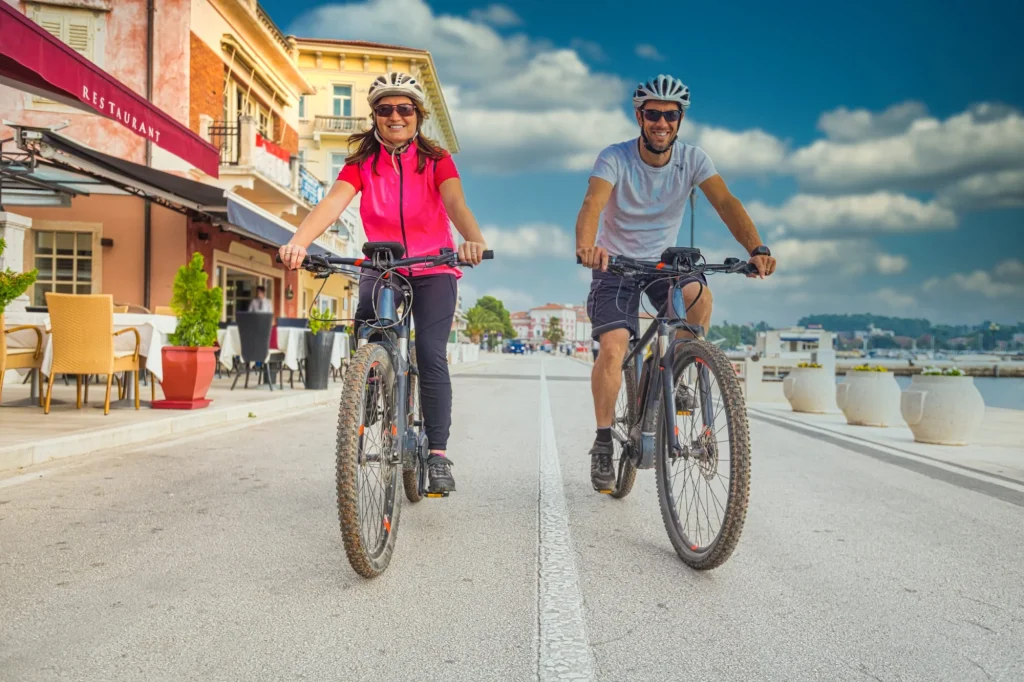Active couple riding an E-Bike during vacations in the south