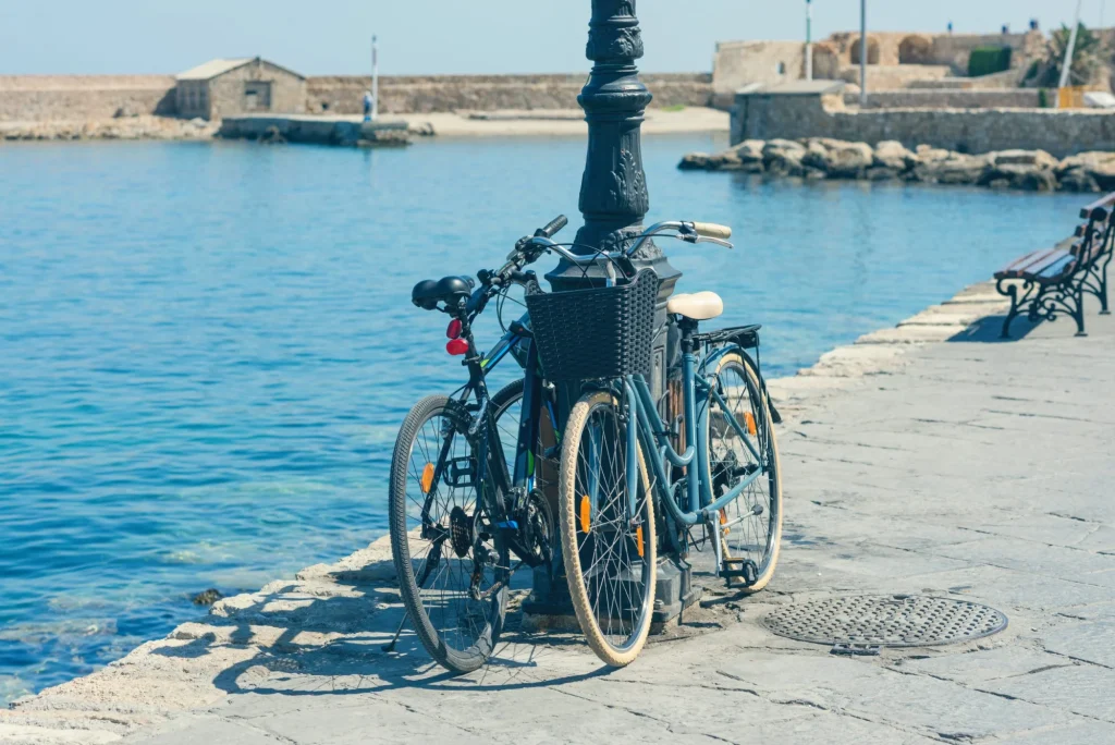 Bicycle on the quay of the old Venetian harbor on the Chania town background. Island of Crete. Greece