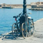 Bicycle on the quay of the old Venetian harbor on the Chania town background. Island of Crete. Greece
