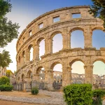 Panorama medieval Ancient Roman Amphitheater in Pula at dawn, Croatia. Architecture and landmark of Croatia. Travel concept background.