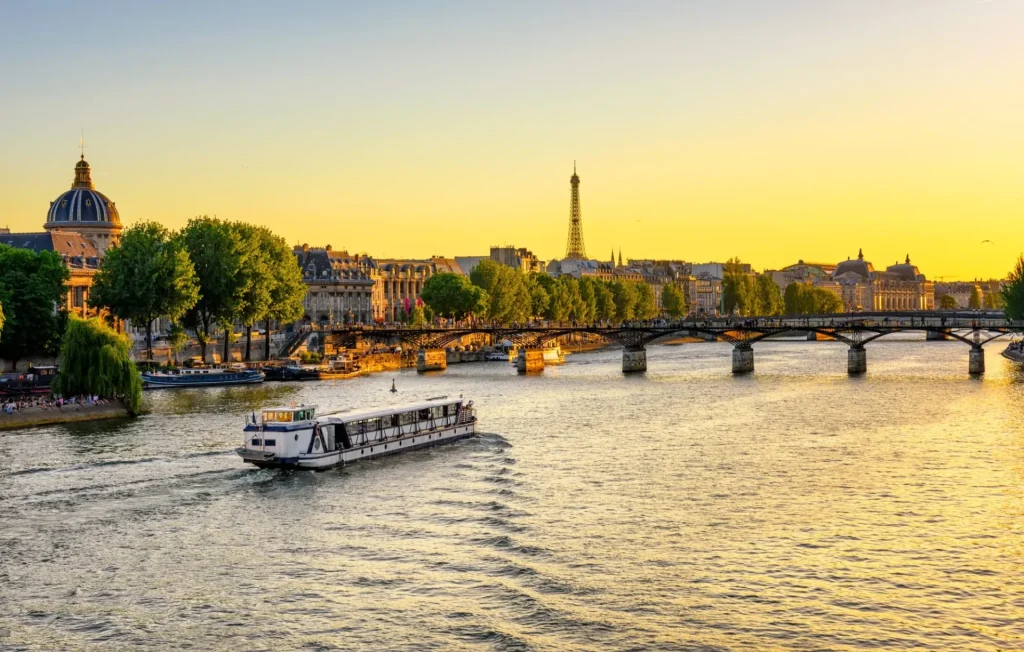 Sunset view of Eiffel tower, Pont des Arts and Seine river in Paris, France